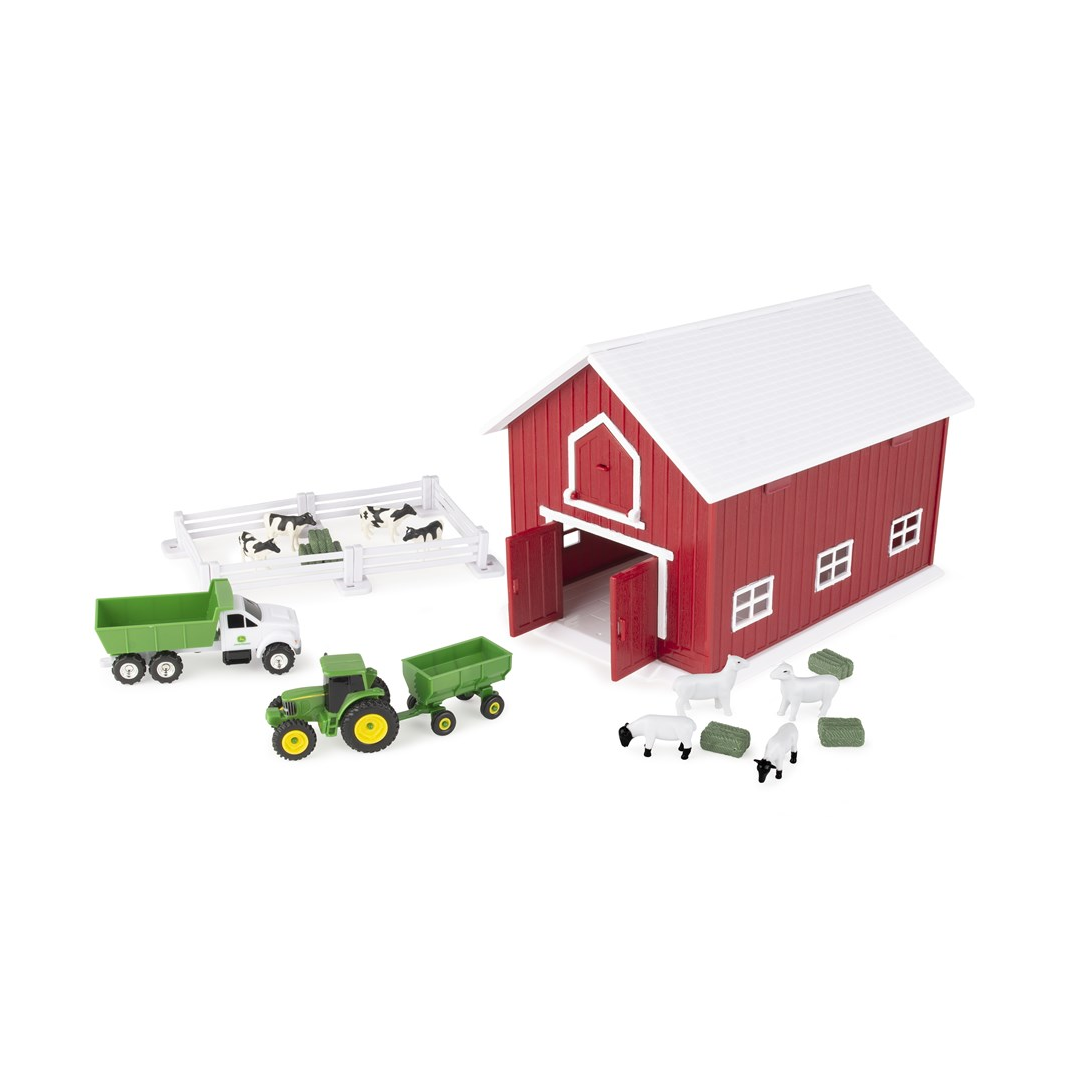 Red barn playset with farm animals, fencing, hay bales, truck, tractor and wagon on a white background