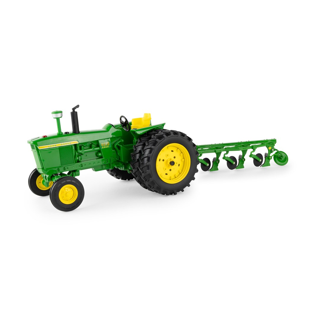 Green and yellow JD 4010 wide-front tractor model attached to a four-bottom plow on a white background